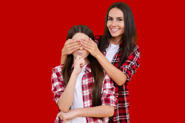 Surprised mother and little daughter. Family happiness. Fun mom with daughter close eyes with hands. Play guess who or hide and seek. Family day. Surprise and family love. Surprise for daughter.