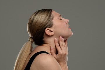 Woman Experiencing Throat Pain or Discomfort in Profile View
