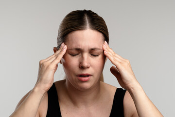 Woman Experiencing a Headache and Holding Her Head