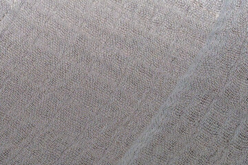 cotton fabric cloth background, natural textile close up, wavy textile surface in mocha mousse brown color with diagonal fold, full frame