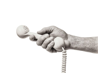 A seniors hand holds a vintage white telephone receiver isolated on transparent background