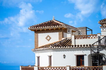 A peaceful walk through the charming narrow streets, surrounded by whitewashed houses and colorful flowers in Frigiliana, Spain