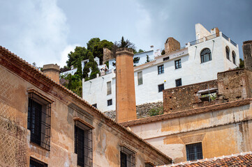 A peaceful walk through the charming narrow streets, surrounded by whitewashed houses and colorful flowers in Frigiliana, Spain