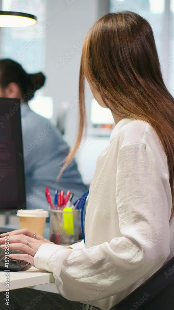 Poster vertical video young programmer in office requests help from it experts detecting and blocking hacke