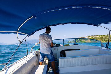 The boat  driver on lake Garda Castle in Sirmione, Italy