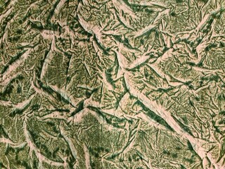 Crumpled handmade paper creating a textured green background