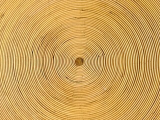 Concentric circles forming hypnotic pattern on rattan surface