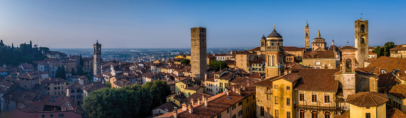 Obraz premium Aerial view of Bergamo’s Città Alta in Italy with terracotta rooftops, historic churches, and mountain backdrop