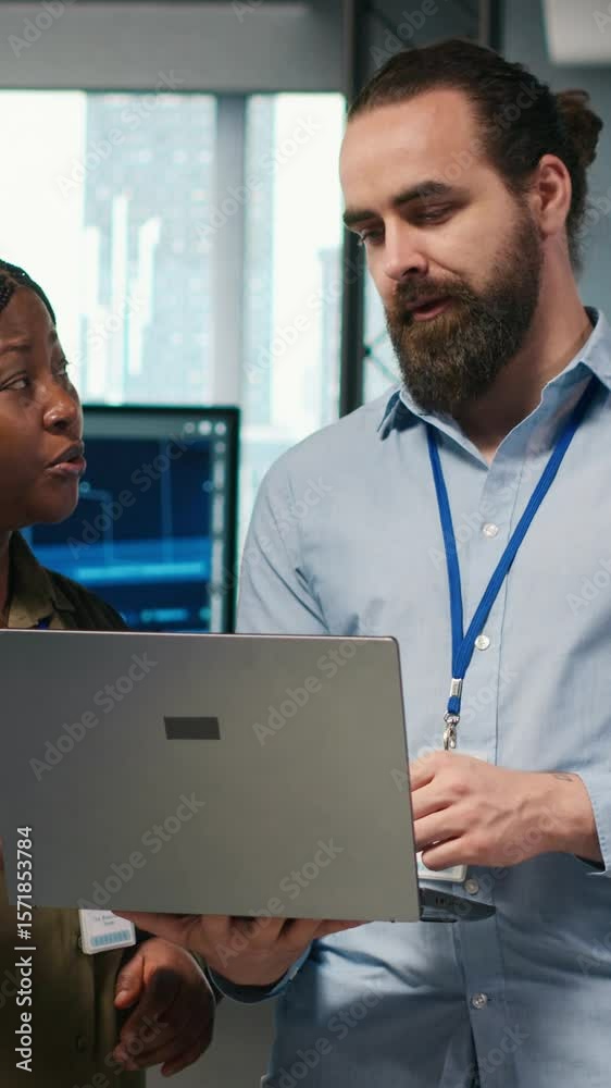 Poster vertical video teamworking programmers in office reviewing ai system metrics, monitoring performance