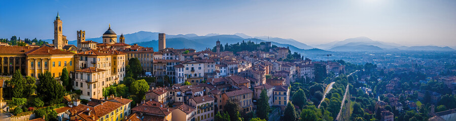 Aerial view of Bergamo’s Città Alta in Italy with terracotta rooftops, historic churches, and...