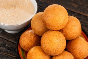 Fried cheese buñuelos accompanied by a hot chocolate drink - Typical Colombian cuisine