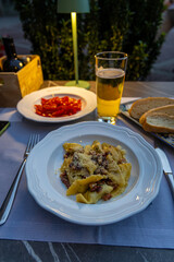 Food in Bergamo’s Città Alta in Italy with terracotta rooftops, historic churches, and mountain backdrop on a clear day