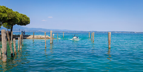 The boat  driver on lake Garda Castle in Sirmione, Italy