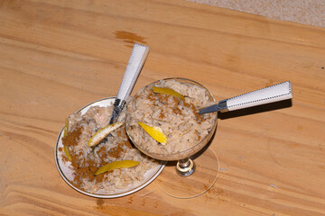 Rice pudding with cinnamon , on a dish , on the table