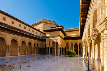 Fototapeta premium The Court of the Lions, or Palace of the Lions, an ornately decorated courtyard in the historic citadel complex of the Alhambra, in the Andalusian city of Granada, Spain. 