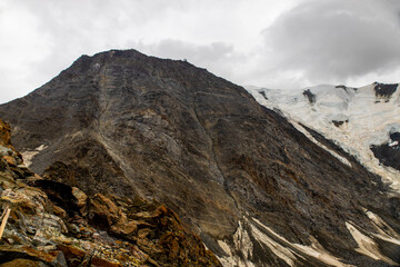 Fototapeta premium Grand Couloir or Death couloir on Mont Blanc ascent through rocky slope and snow patches, showing high-altitude alpine terrain, mountaineering route, glacier environment steep dangerous landscape