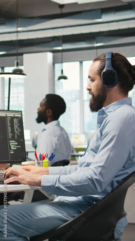 Poster vertical video software developer coding with ai language model assistance in office, listening musi