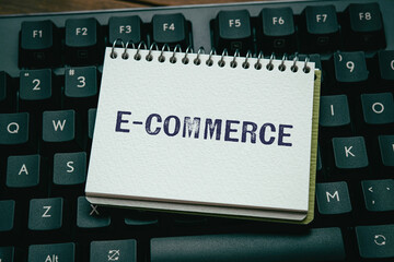 There is notebook with the word e-Commerce. It is as an eye-catching image.