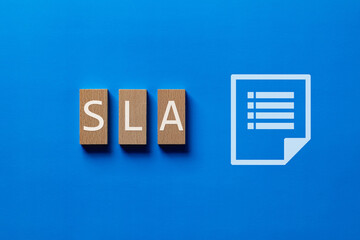 There is wood block with the word SLA. It is an abbreviation for Service Level Agreement as...