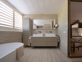 Luxury marble bathroom with freestanding bathtub, wall-mounted toilet, glass shower, and brass fixtures throughout