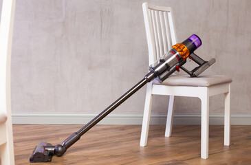 Practical modern handheld vacuum equipped with functional brush for cleaning floors and carpets,...