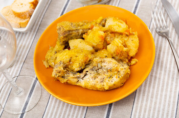 Just cooked braised chicken with potatoes served on table.