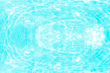Blue water with ripples on the surface. Defocus blurred transparent blue colored clear calm water surface texture with splashes and bubbles. Water waves with shining pattern texture background.