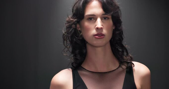 Studio, woman and face with fashion for runway, event and presentation with outfit by mockup. Female person, model and portrait with pride for clothing show, designer brand or black background