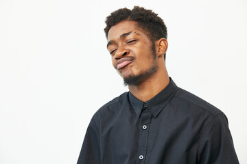 Confident black man in a stylish black shirt, showcasing his unique personality. The expression...