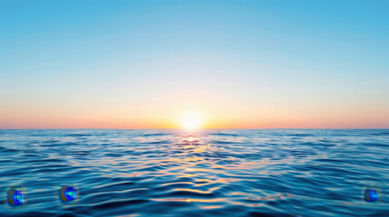 The ocean is calm and the sun is setting, creating a serene