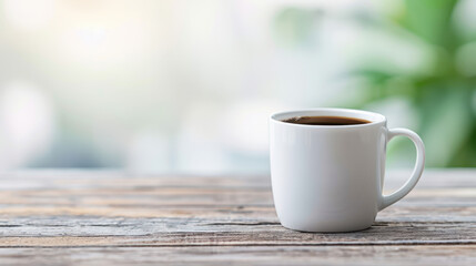 A white coffee cup sits on a wooden table