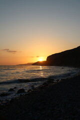 Golden sunset over Palos Verdes Cliffs with waves, rocky shores, wild grasses, and dramatic silhouettes capturing California’s rugged coastal beauty and peaceful ocean horizon.