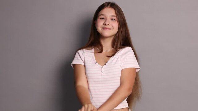 Teenage girl in casual clothes on grey background