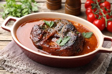Traditional ossobuco dish with beef steak and sauce served on table, closeup