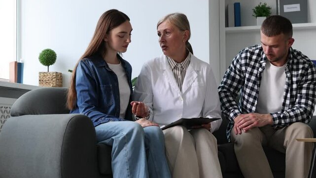 In vitro fertilization (IVF). Doctor supporting couple during appointment in reproductive clinic