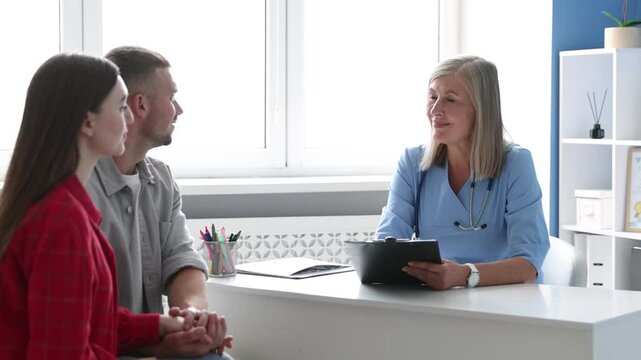 In vitro fertilization (IVF). Doctor consulting young couple in reproductive clinic