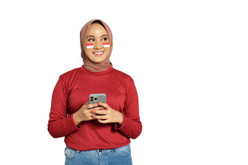 Happy young Asian women celebrate Indonesian independence day on 17 August while holding mobile phone isolated on transparent background