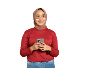 Happy young Asian women celebrate Indonesian independence day on 17 August while holding mobile phone isolated on transparent background