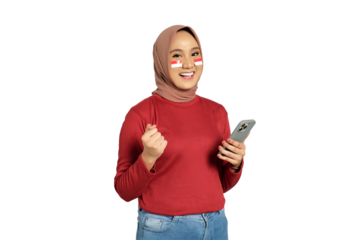 Excited young Asian women celebrate Indonesian independence day on 17 August while holding mobile phone isolated on transparent background