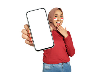 Surprised young Asian women celebrate Indonesian independence day on 17 August while holding smartphone with blank screen isolated on transparent background