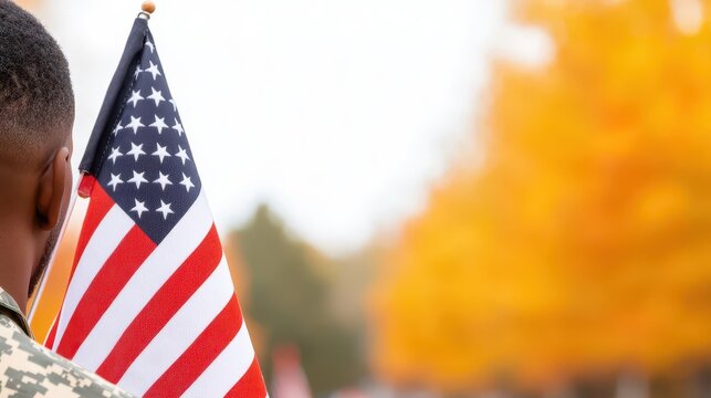 Community gathered for Veterans Day parade, waving flags in remembrance