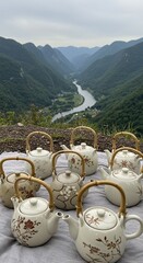 Teapots with Bamboo Handles and Floral Designs Overlooking a Scenic Valley