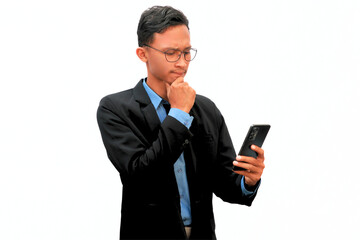 An Asian business man holding a cell phone with a thoughtful expression.