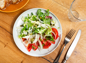 Delicious fresh vegetable salad with tomato and onion served on plate