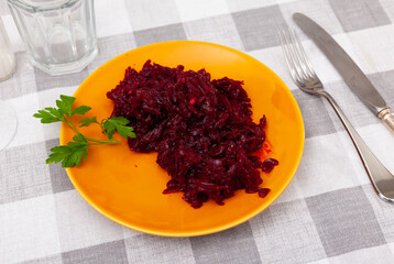 Delicious healthy salad of shredded boiled beets served with fresh greens