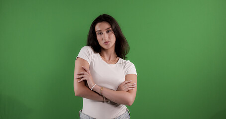 Confident young woman crossing her arms on chroma key background, ideal for advertising and...