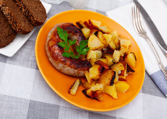 Tasty dinner, grilled pork sausage served with potato