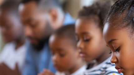 Family praying at dinner table