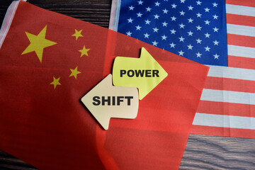 Concept of Power shift write on sticky notes with united state flag and china flag isolated on Wooden Table.
