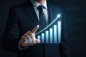 Businessman pointing at glowing upward trend bar graph suit finger